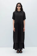 Woman wearing a black espelma pinstripe dress by Rita Row against a white background