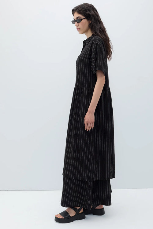 Woman wearing a black espelma pinstripe dress by Rita Row against a white background