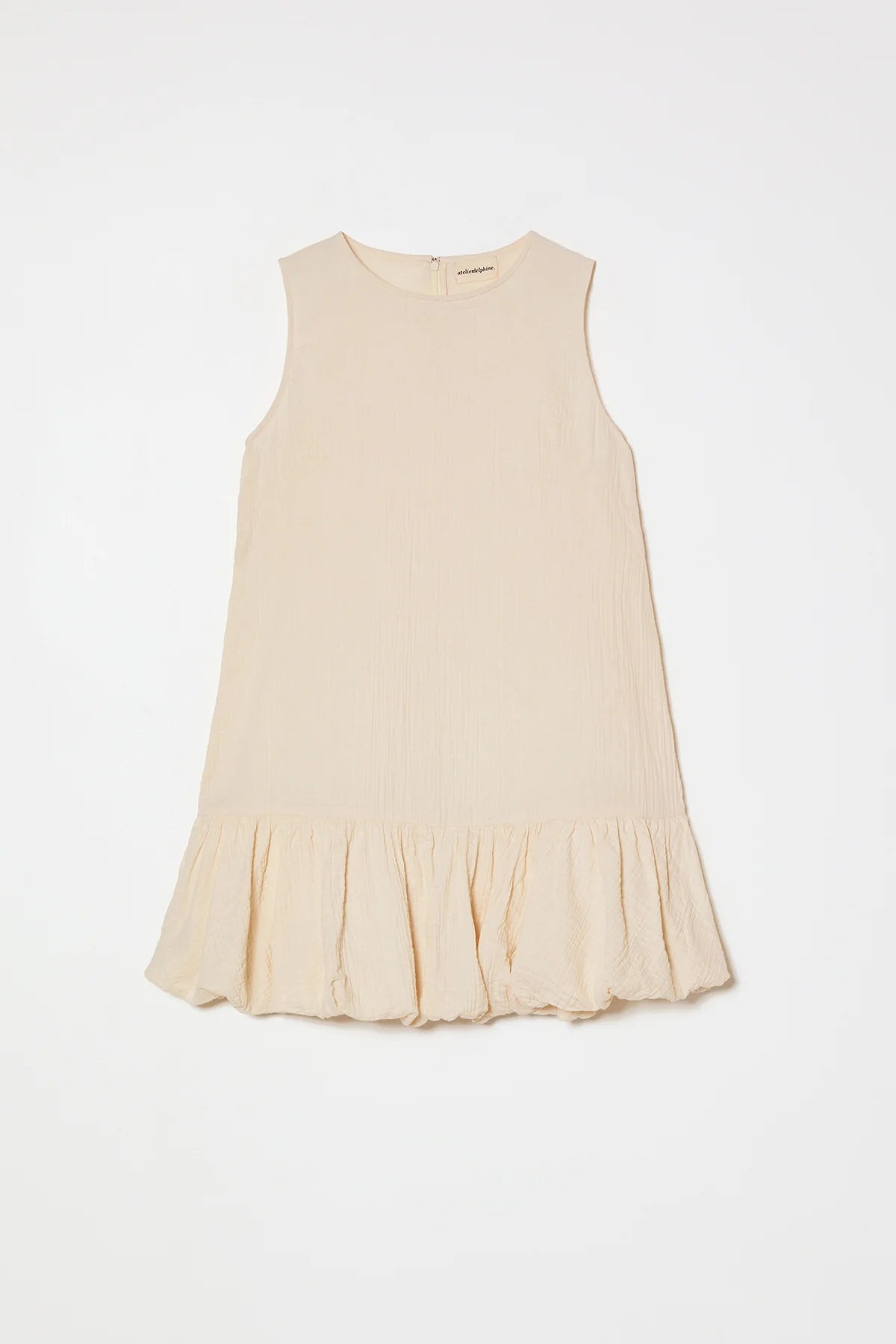 Cream-colored dress by Atelier Delphine with a plain background