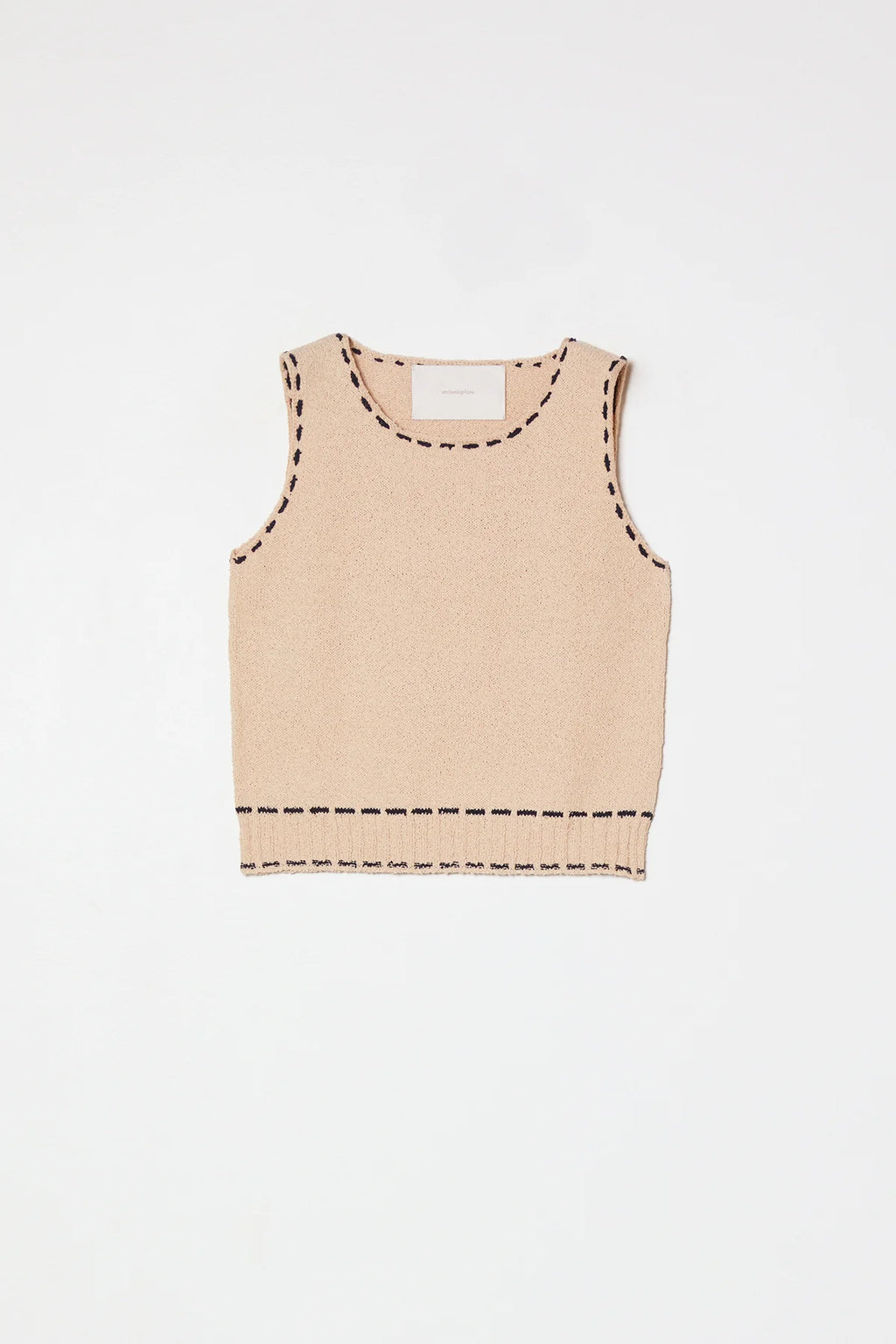 A beige sleeveless top with navy stitching by Atelier Delphine 