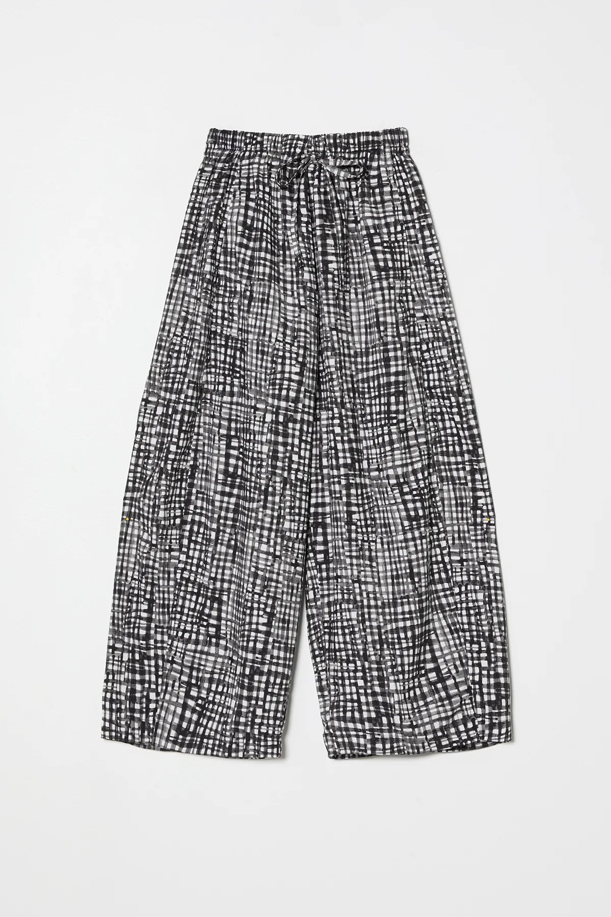 Black and white gingham pants by Atelier Delphine on a light gray background 