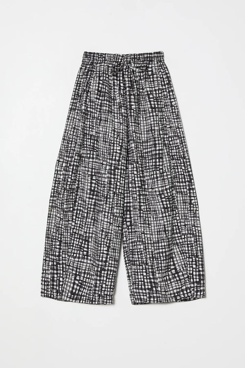 Black and white gingham pants by Atelier Delphine on a light gray background 