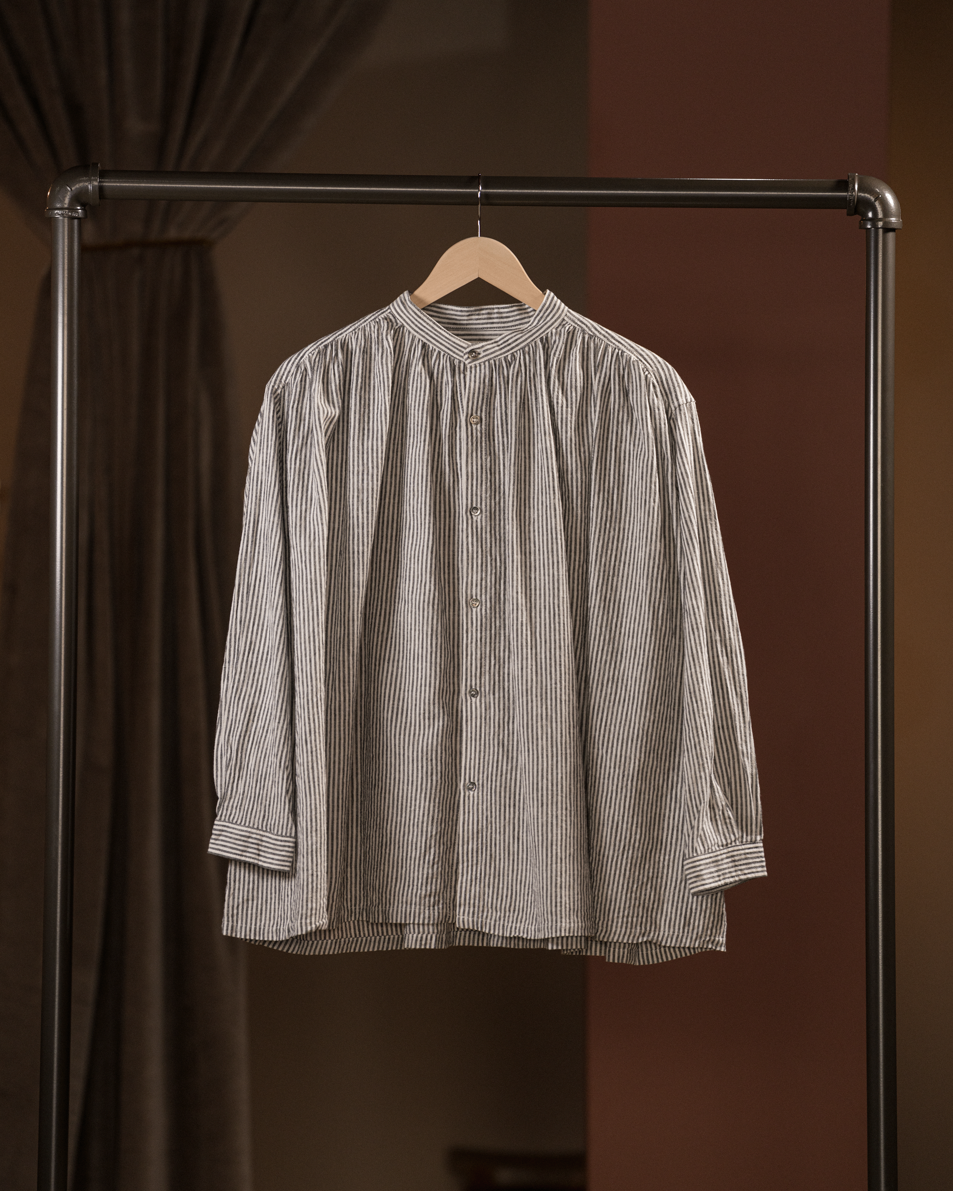 Striped shirt on a hanger against a brown background