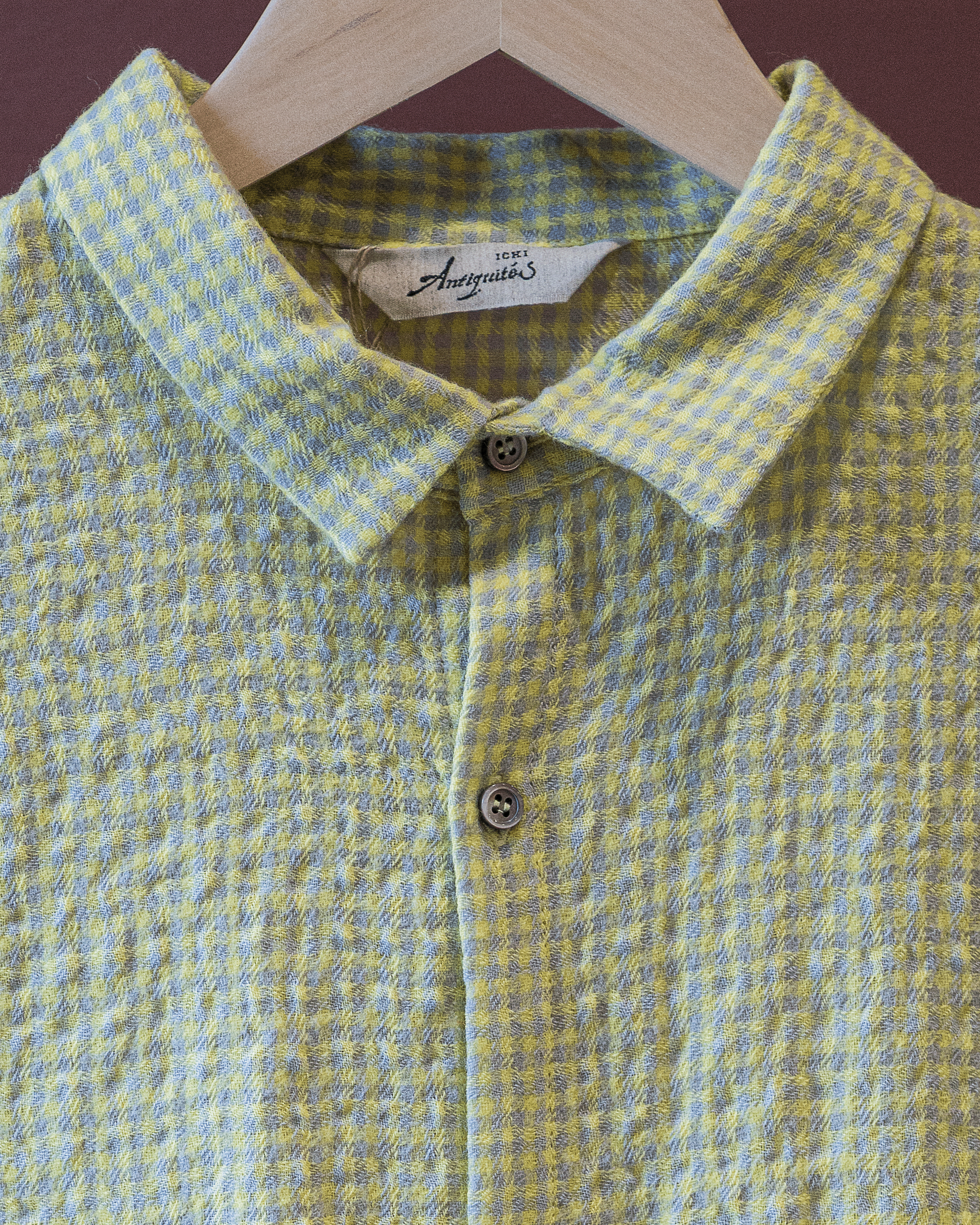 Yellow and blue checkered shirt on a hanger with 'Freigättes' label.
