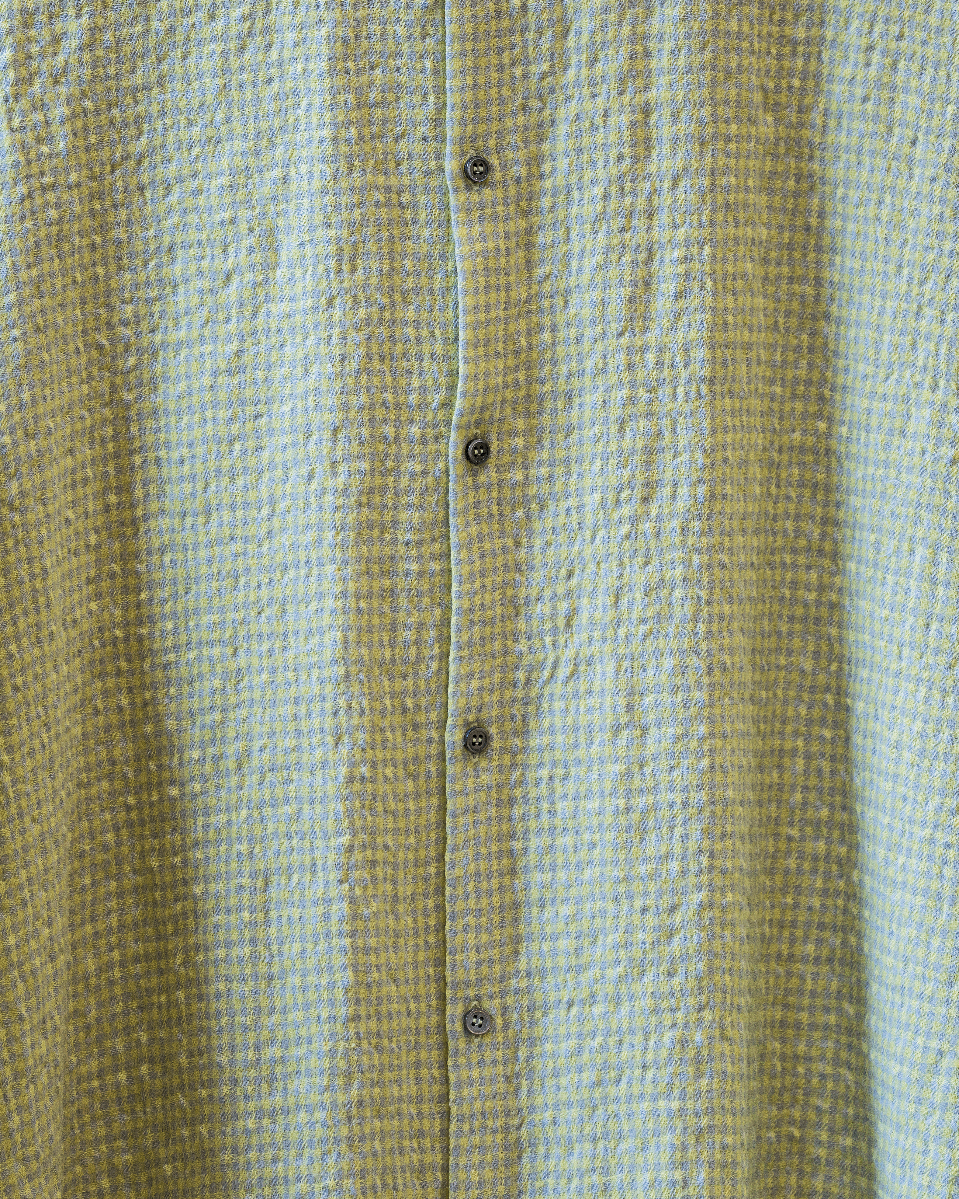 Close-up of a textured fabric with horizontal stripes in green and beige.