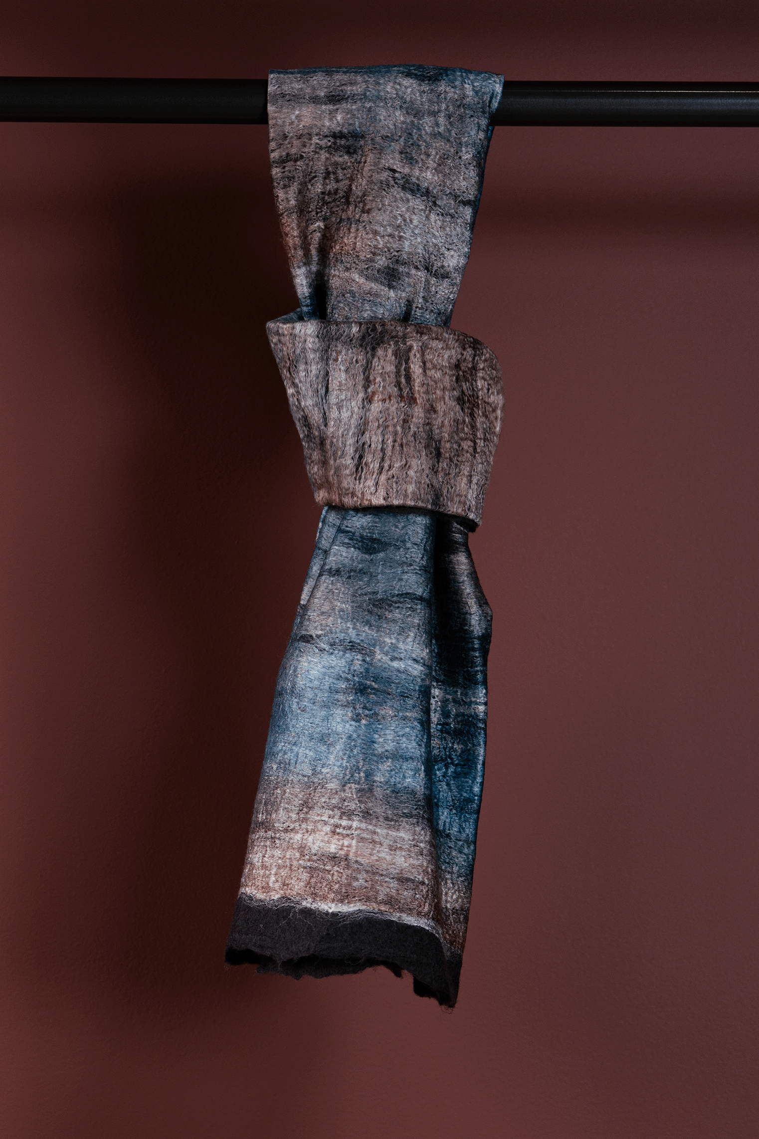 Textured fabric sample on a rod against a brown background