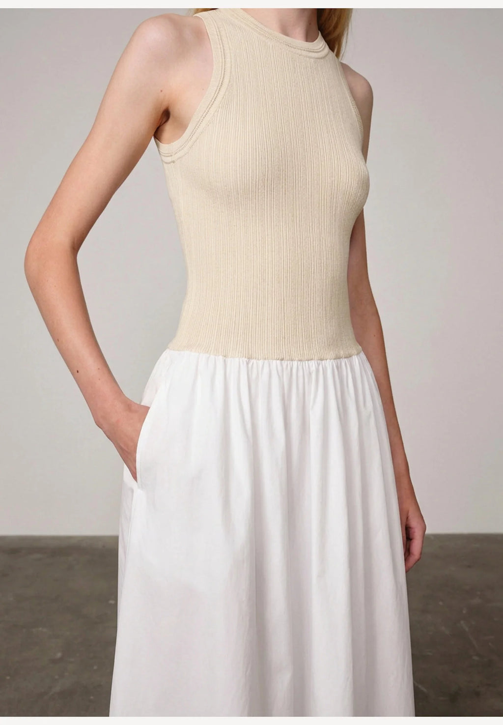 Woman wearing an off white/white watson dress by Herskind against a plain background