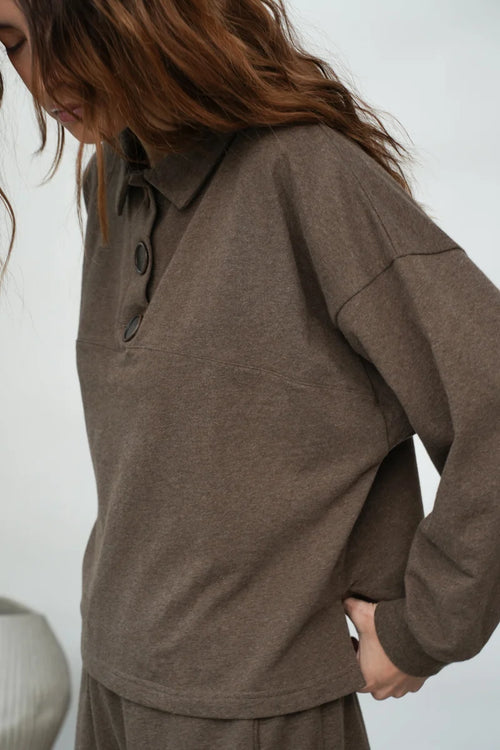 A woman wearing the Holly brown collared Sweatshirt by Beaumont Organic.
