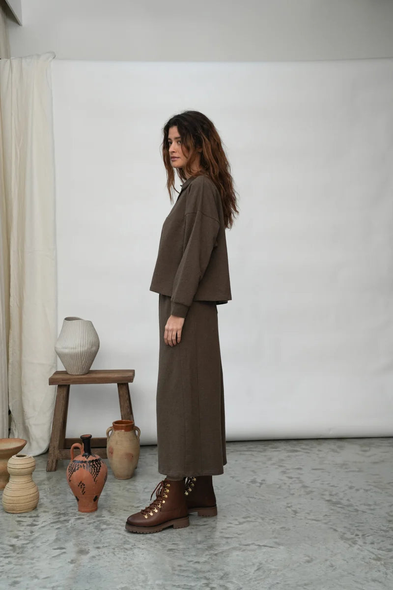 A woman wearing the Holly brown collared Sweatshirt by Beaumont Organic with matching pants.