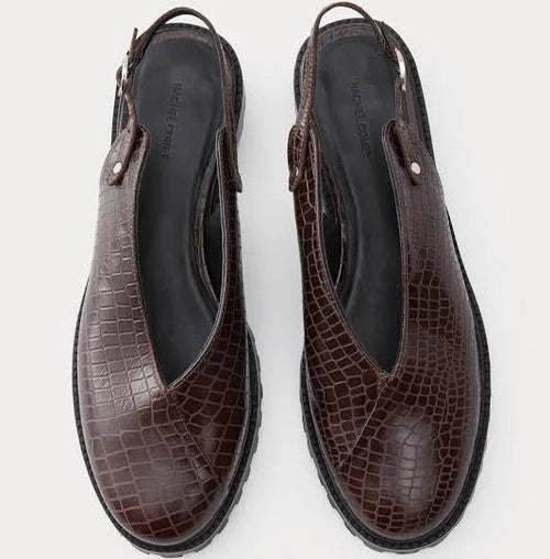 A pair of dark brown clog-style slingback Lenox Lug shoes by Rachel Comey with an embossed crocodile pattern, black platform soles, and adjustable ankle straps, shown against a light gray background.