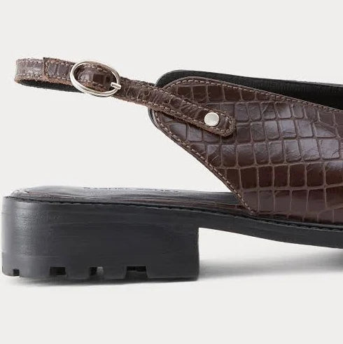 A pair of dark brown clog-style slingback Lenox Lug shoes by Rachel Comey with an embossed crocodile pattern, black platform soles, and adjustable ankle straps, shown against a light gray background.