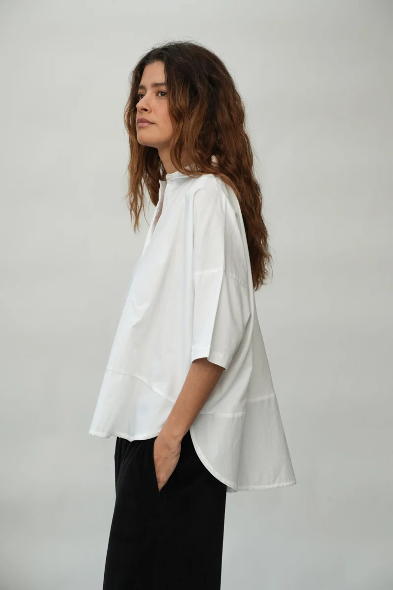 A woman wearing a White Short Sleeve Lissie Blouse by Beaumont Organic