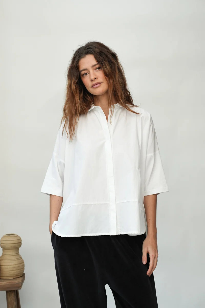 A woman wearing a White Short Sleeve Lissie Blouse by Beaumont Organic
