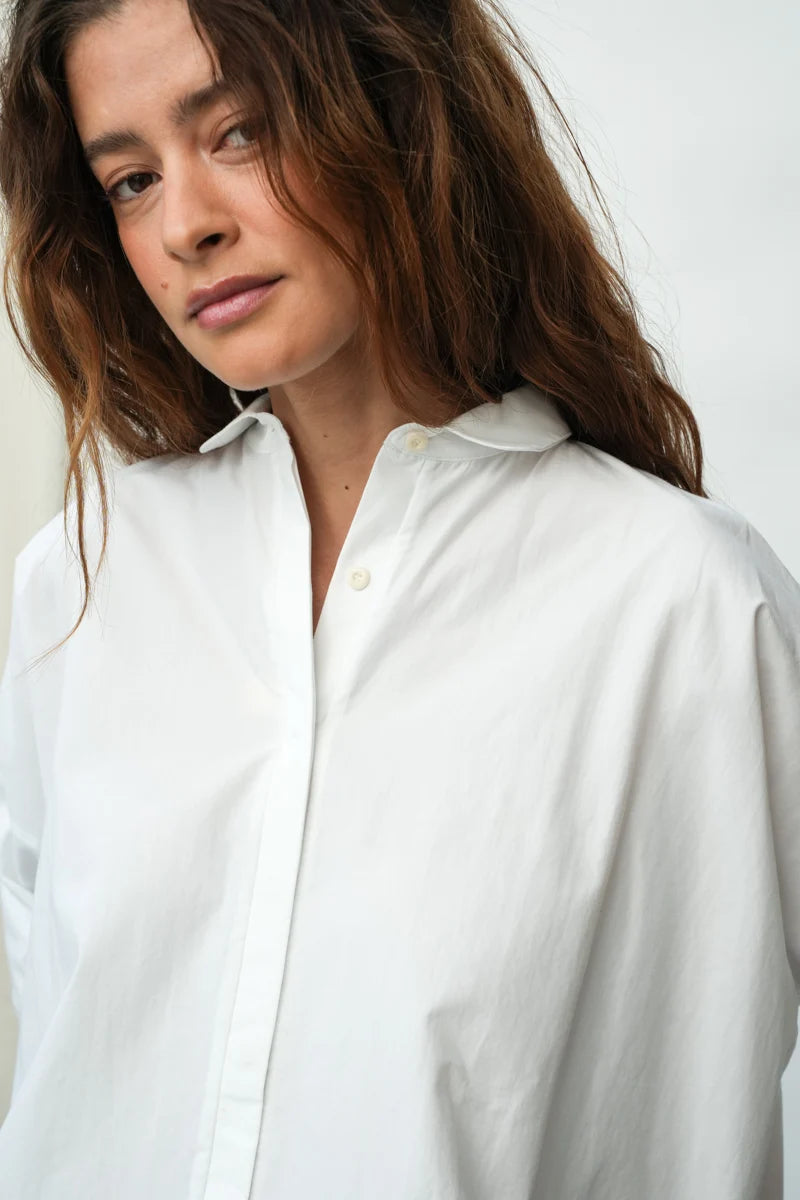 A woman wearing a White Short Sleeve Lissie Blouse by Beaumont Organic