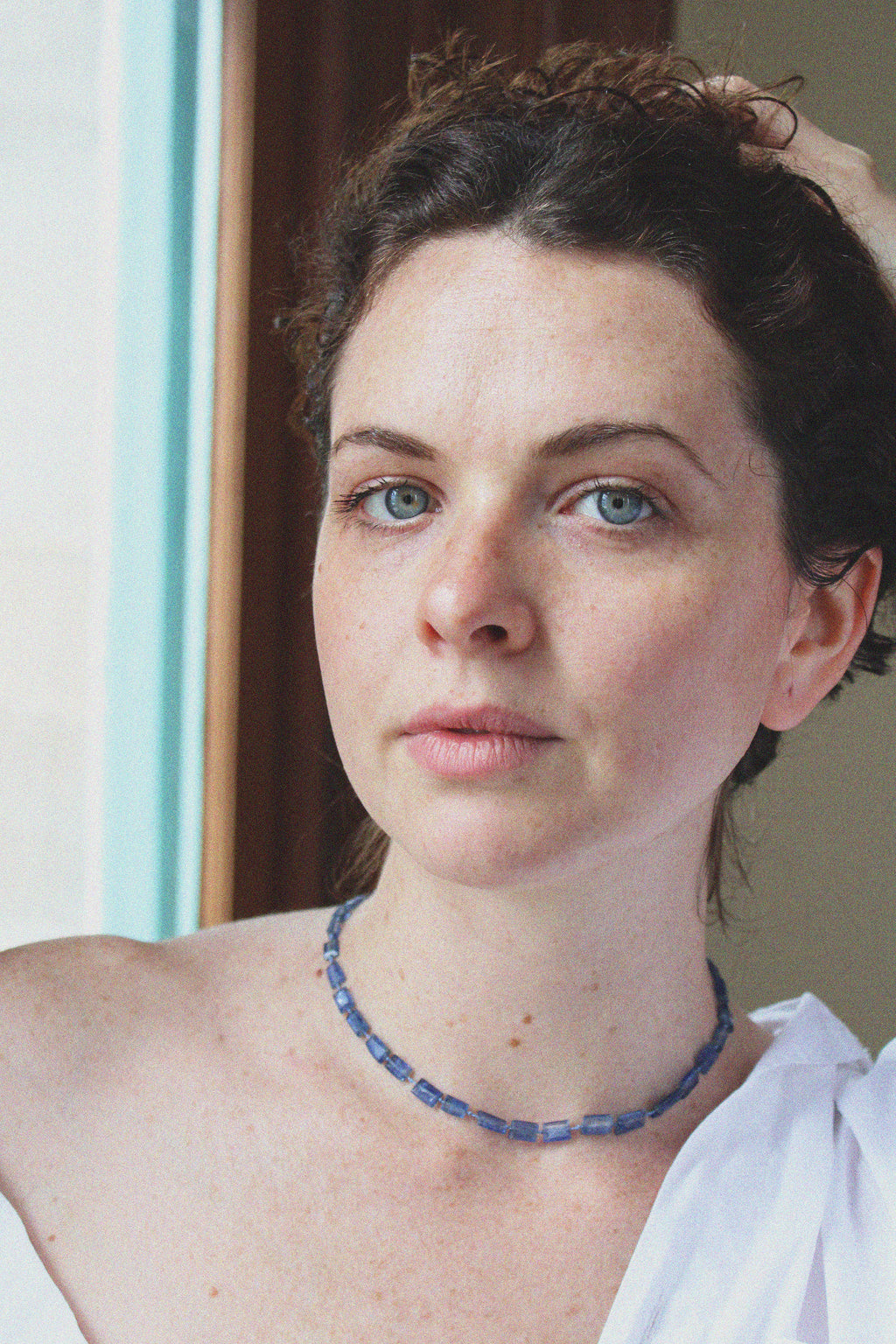 Woman wearing a blue stone midnight necklace by Takara