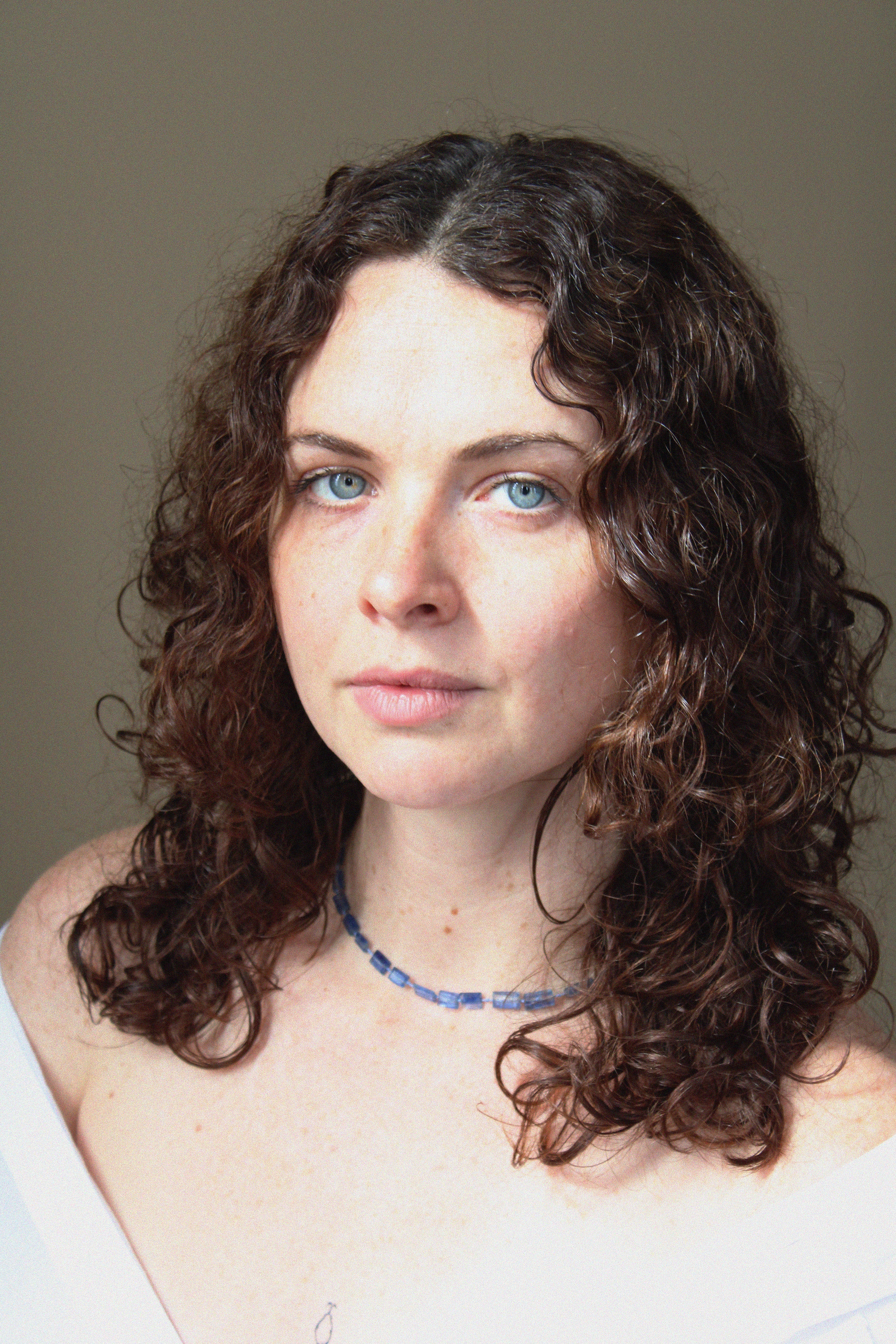 Woman wearing a blue stone midnight necklace by Takara