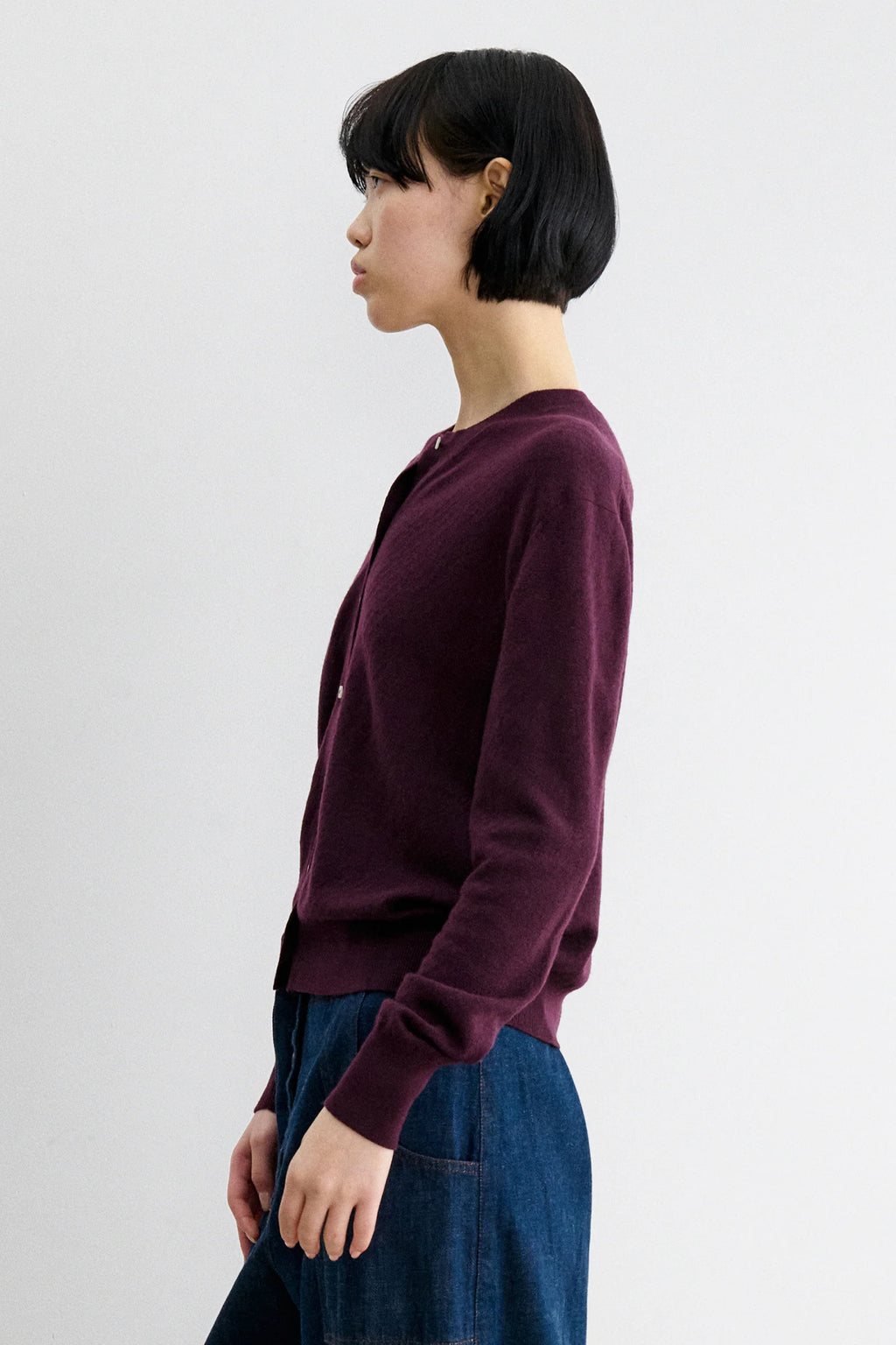 A Model wearing Auburn colored cardigan - Matin Cardigan by Rachel comey and jeans.