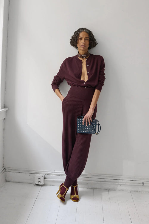 A Model wearing Auburn colored cardigan - Matin Cardigan by Rachel comey and matching pants.