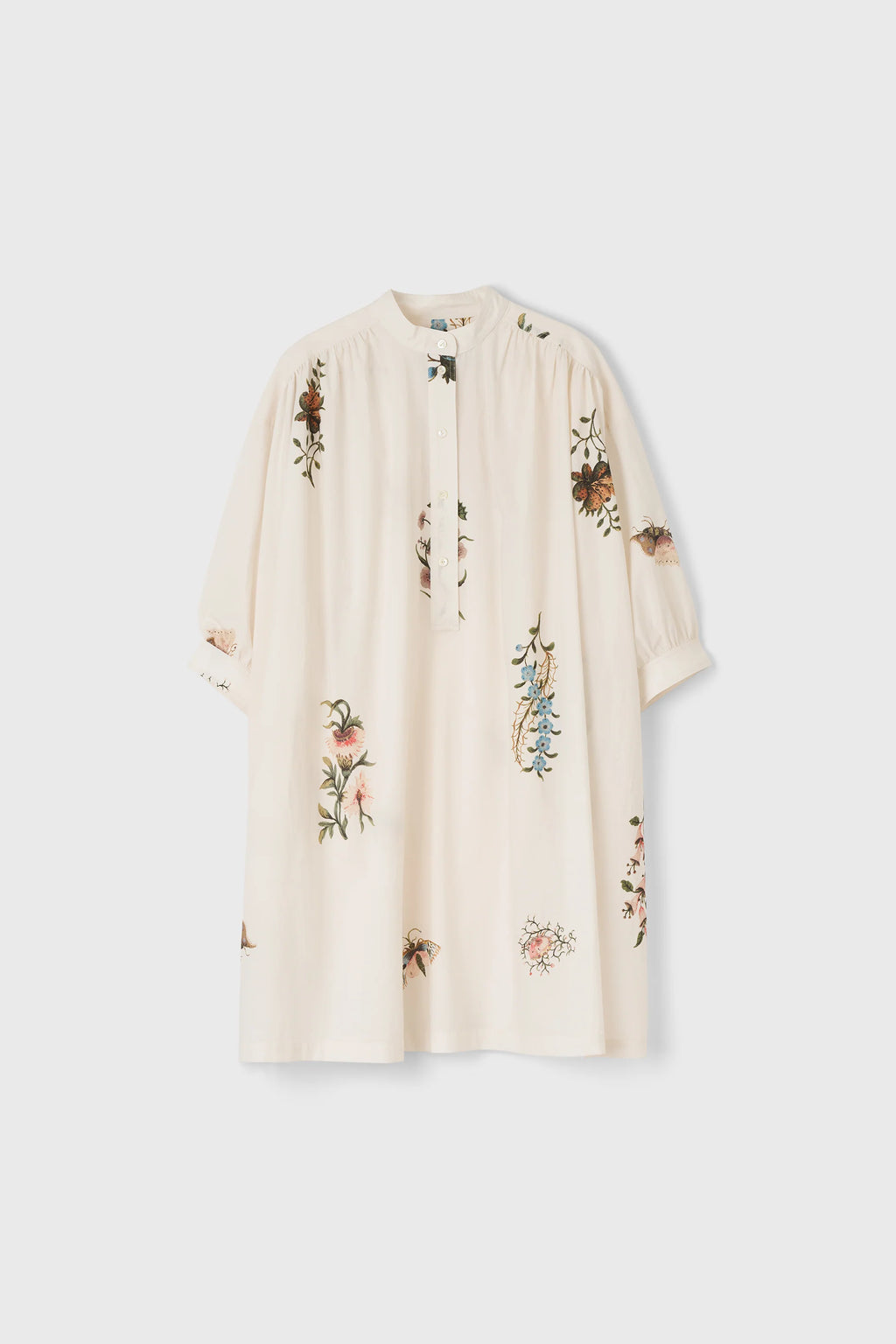Cream dress with floral print on a white background