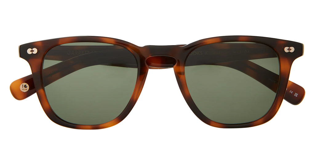 Brown spotted shell sunglasses with smokey lens on a white background.