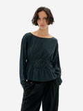 Woman waring Faded Dark Green striped Devin Blouse by Thinking Mu on a white background.