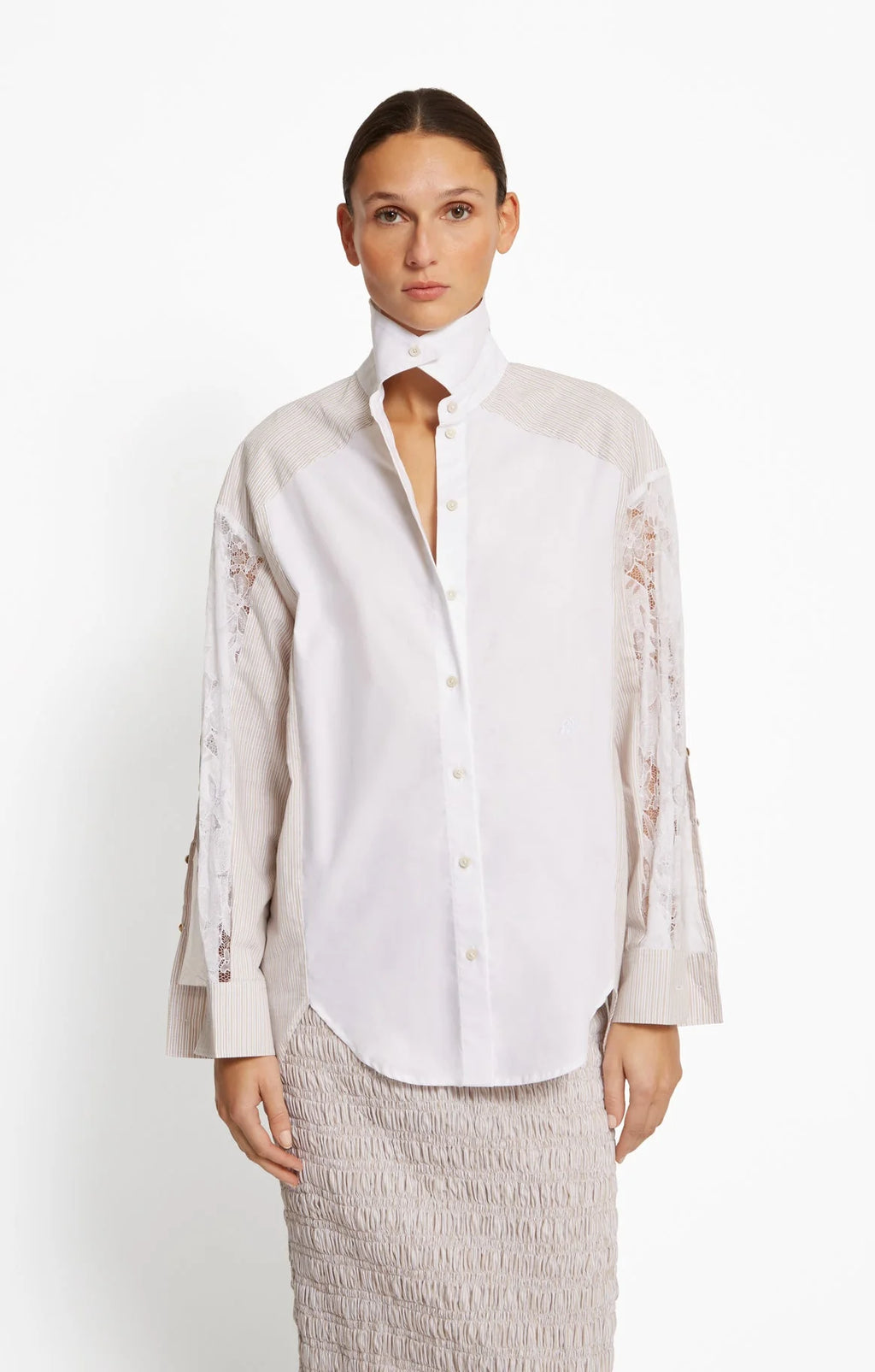 Woman wearing a white blouse with lace cut on sleeves on a white background