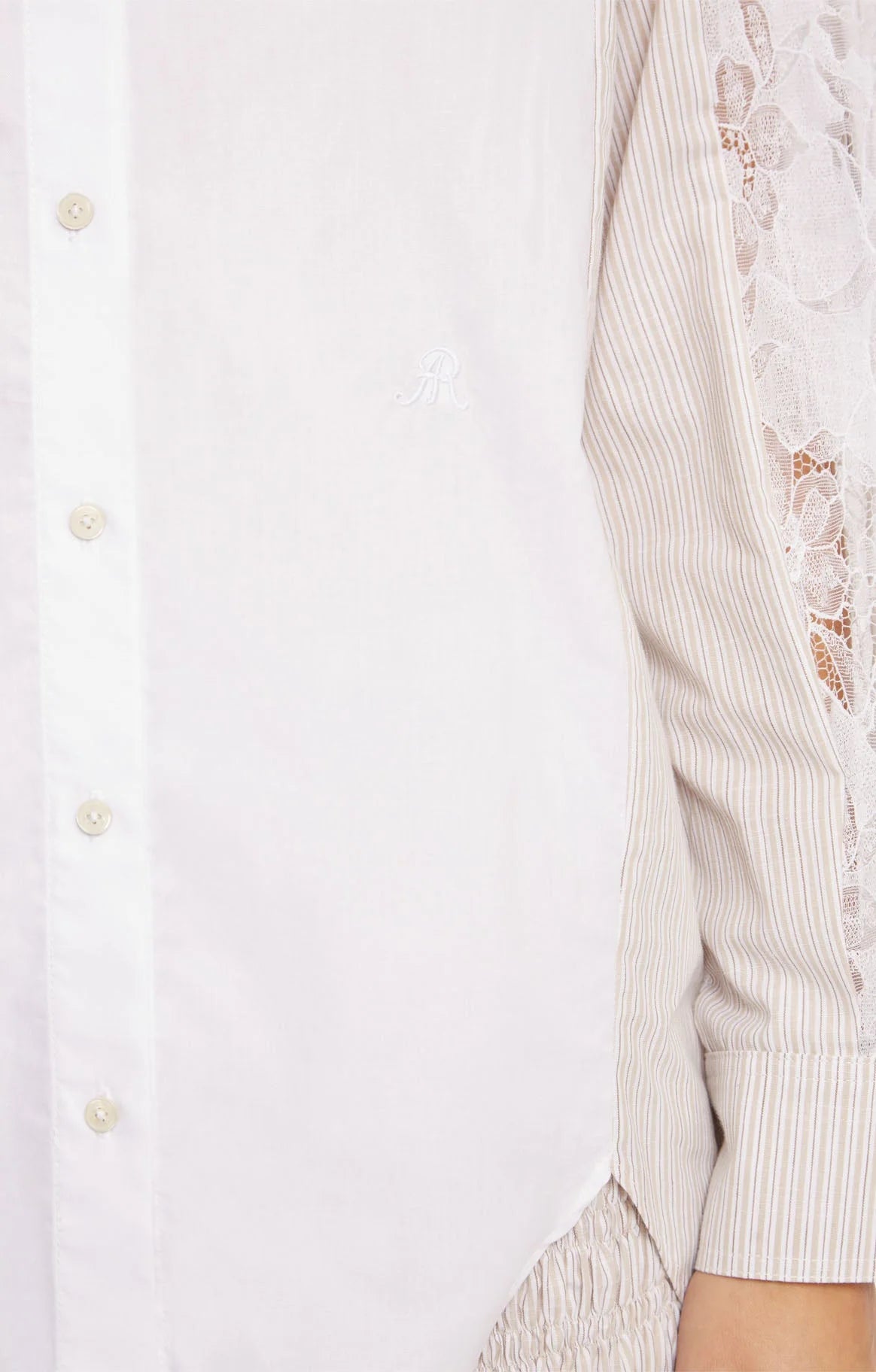 Close-up of a white shirt with lace on sleeves on a plain background