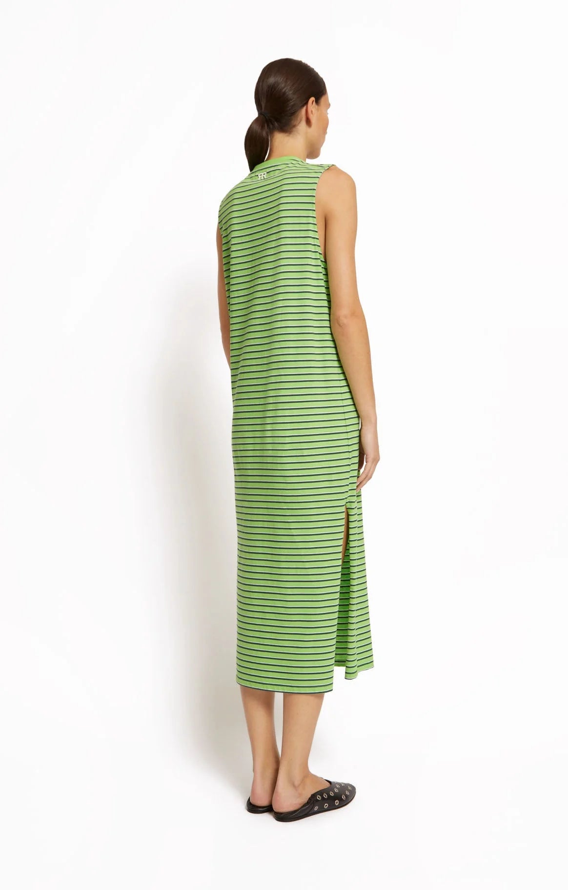 Woman wearing a green striped dress by Roseanna against a white background