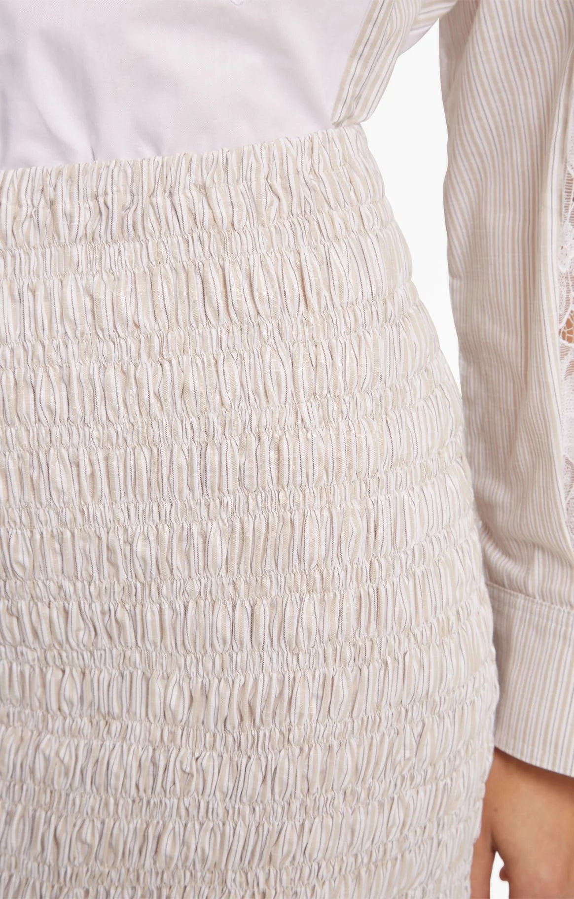 Close-up of a textured beige skirt with a blurred background