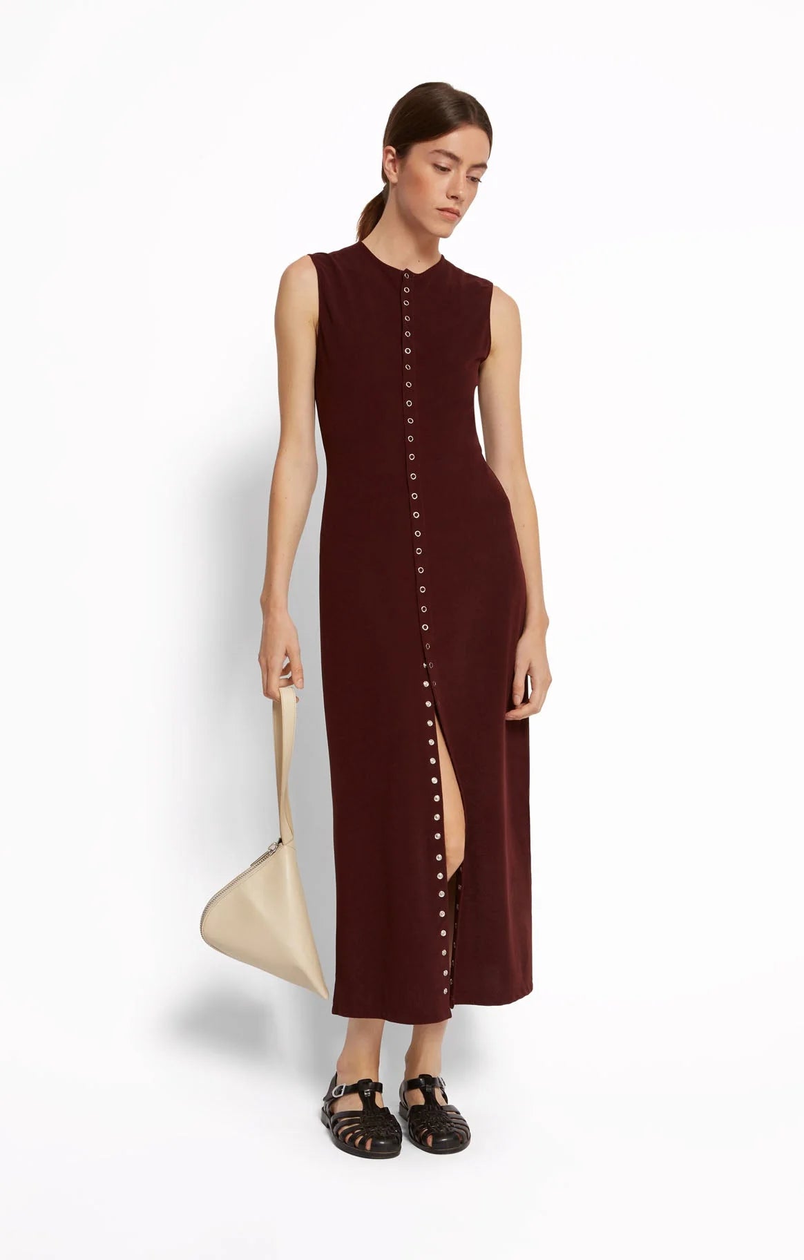 Woman wearing a cherry red snap fron sleeveless dress by Roseanna